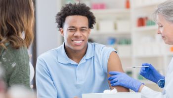 African American man makes a face while receiving injection