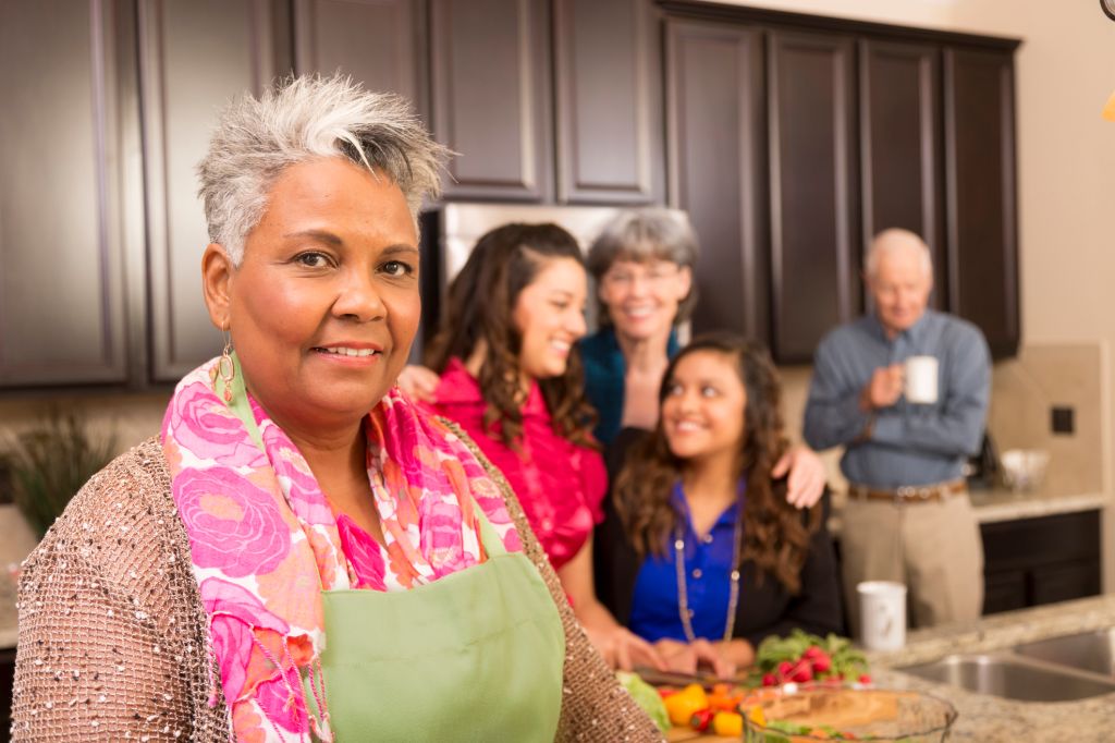 Relationships: Senior woman, family and friends cook in home kitchen.
