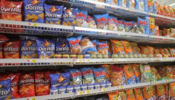 Shelves of potato chips for sale at Walmart.