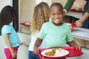 Elementary Pupils Collecting Healthy Lunch In Cafeteria