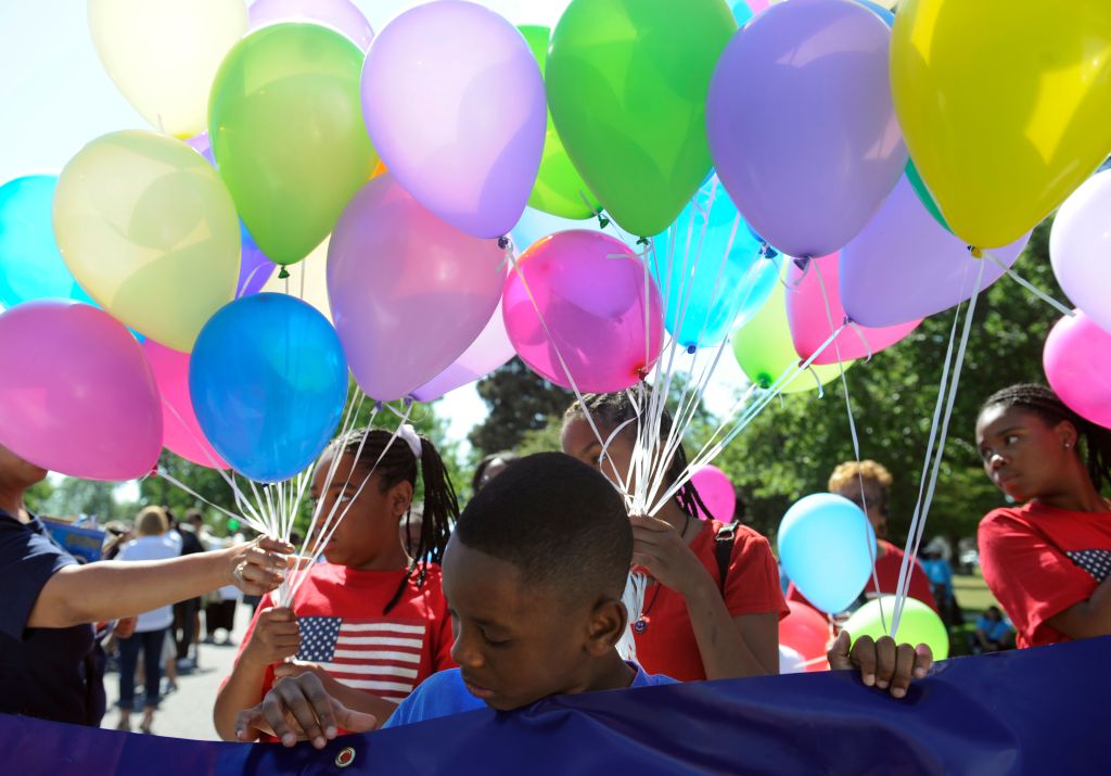 Brian Harris, 8, waits for the parade to begin with his mom and other employees from US Bank. The Friends of Blair Caldwell African American Research Library Foundation hosts the 2011 Denver Juneteenth Celebration: We Define Who We Are, on Saturday, June