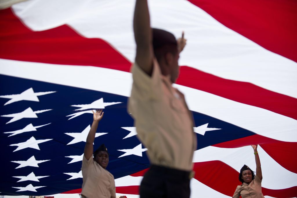 Members of the US Navy's JROTC hold up a