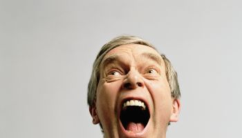 Mature man yelling, close-up, low angle view