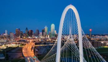Elevated View of the Margaret Hunt Bridge and the Dallas Skyline at Dusk