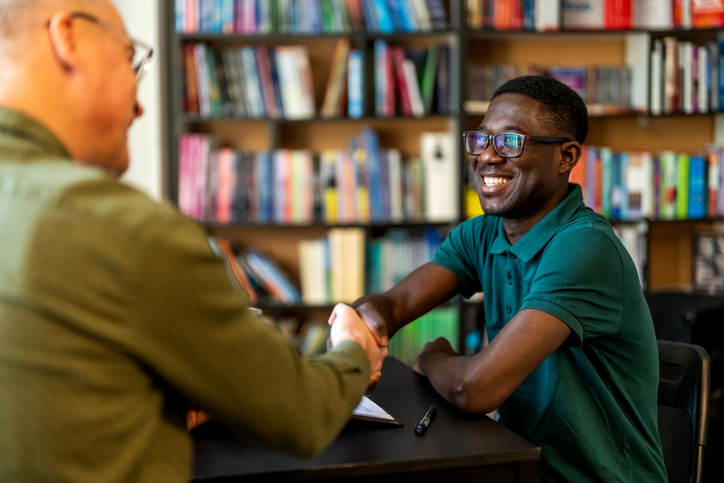 Young man successful job applicant shake man hr hand
