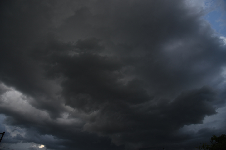 Dramatic dark storm rain clouds black sky background. Dark thunderstorm clouds rainny atmosphere. Meteorology danger windstorm disasters climate. Dark cloudscape storm disaster gloomy gray cloud sky