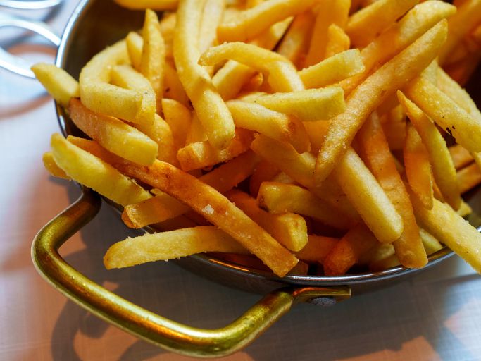 Golden Crispy French Fries in a Small Skillet Evoking Feelings of Comfort and Indulgence